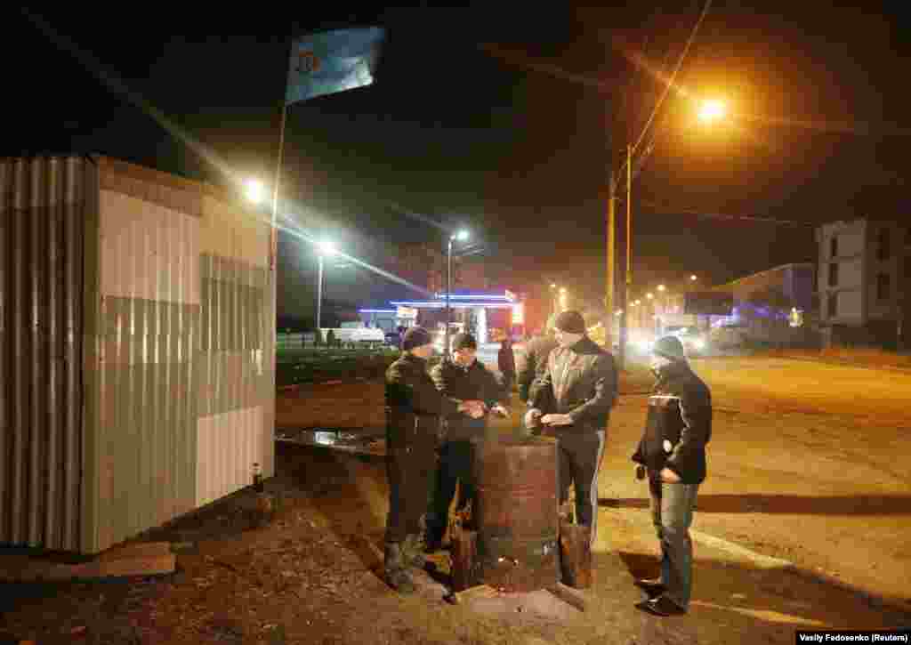 Crimean Tatars warm themselves around a fire while guarding their neighborhood on March 9. Ukraine&rsquo;s interim Prime Minister Arseniy Yatsenyuk vowed Ukraine would not relinquish &quot;an inch&quot; of its territory as Russia&rsquo;s takeover of Crimea solidified and life became increasingly dangerous for locals opposed to the illegal annexation. &nbsp;
