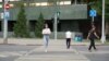 Kazakhstan - a woman crossing street. Astana, 17 July 2023