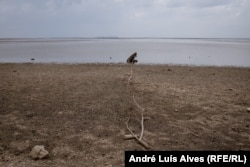 The Kakhovka reservoir is almost dry, with water flowing only through the river channel.