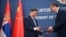 Chinese leader Xi Jinping (left) and Serbian President Aleksandar Vucic exchange agreements during a signing ceremony on May 8 in Belgrade.