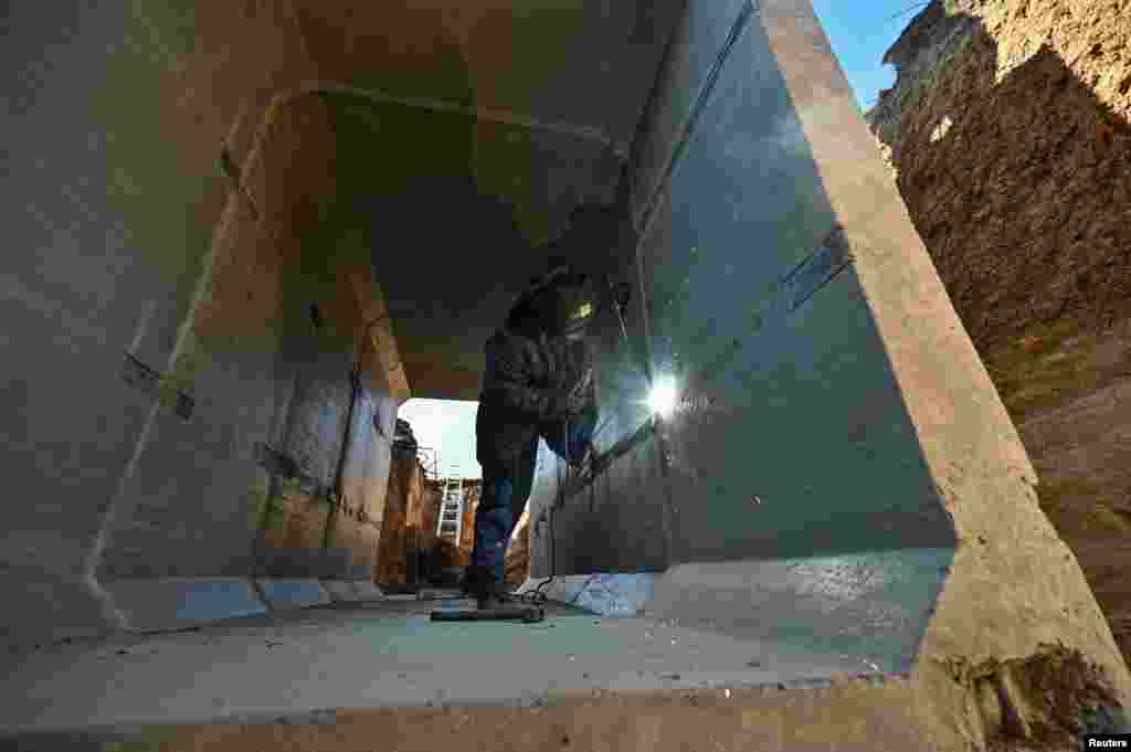 A worker welds inside a concrete dugout.&nbsp; &quot;The situation is much better than it has been over the past three months,&quot; Zelenskiy said. &nbsp;