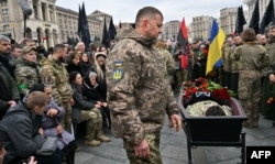 The commander in chief of Ukraine's armed forces, Lieutenant General Valeriy Zaluzhniy, pays his respects during the farewell ceremony for Dmytro Kotsyubaylo on Independence Square in Kyiv on March 10.