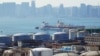 A Chinese vessel is seen near oil tanks at the China National Petroleum Corporation's petrochemical facility in Dalian, China.