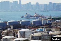 Китайский танкер у нефтяных резервуаров на нефтехимическом заводе China National Petroleum Corporation в Даляне, Китай