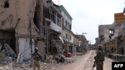 پاکستاني پوځيان د ميرامشا په وران کړي بازار کې ولاړ دي. د ۲۰۱۴ کال د جولای د میاشتې انځور