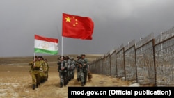 Frontier-defense troops of China and Tajikistan conduct a joint patrol along the Chinese-Tajik border in 2017.