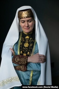 Ельміра в традиційному костюмі кримських татар. Золоті монети, якими прикрашали феси, часто зрізали і продавали, щоб вижити в місцях депортації