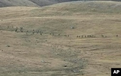 This image taken from YouTube footage released by the Armenian Defense Ministry on September 13 reportedly shows Azerbaijanian troops crossing the Armenian-Azerbaijani border and approaching Armenian positions.