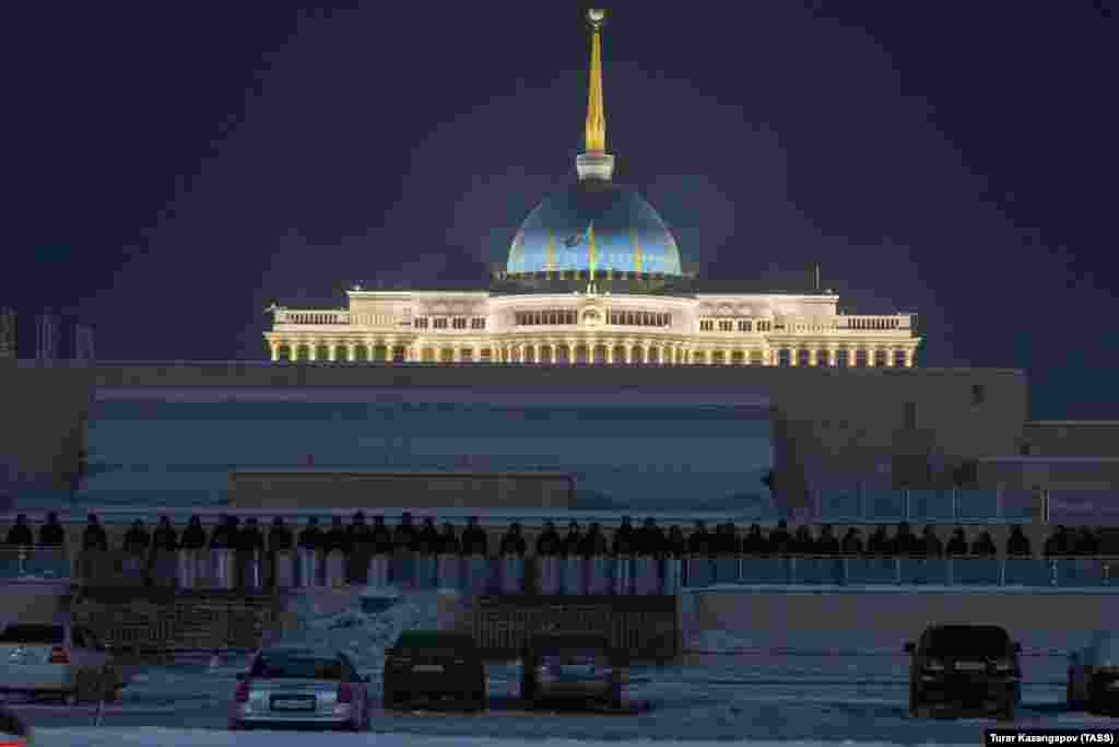 A wall of security forces lines the perimeter of the presidential palace in Nur-Sultan. The Kazakh capital city has been relatively quiet as deadly violence has swept Almaty.&nbsp;