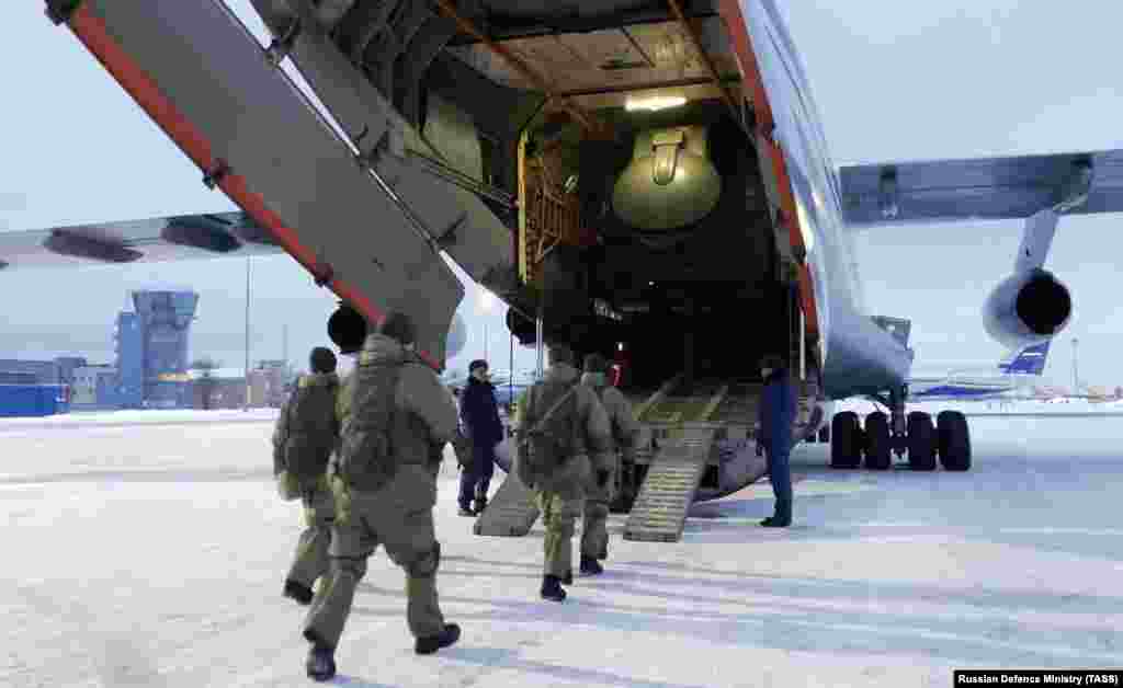 Russian airborne troops bound for Kazakhstan board a transport plane at Chkalovsky Airfield, northeast of Moscow, on January 6. A day earlier, Kazakh President Qasym-Zhomart Toqaev appealed for the intervention of the Collective Security Treaty Organization (CSTO), blaming foreign-trained &quot;terrorist&quot; gangs for the unrest sweeping his country.