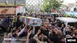 The killing of Ali Esmailzadeh took place within two weeks of the May 22 assassination in Tehran of fellow IRGC member Colonel Hassan Sayad Khodaei, whose funeral procession is pictured here. 
