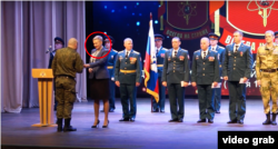 A Gazprombank representative congratulates a Russian military unit on the anniversary of its formation on April 29.