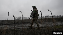 A serviceman of Ukraine's National Police Special Purpose Battalion patrols a frontline position near Pokrovsk in the Donetsk region on November 20.