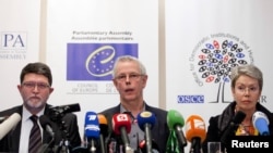 Tiny Kox (center) and other observers from the OSCE and PACE present their assessment in Moscow in March 2012 after monitoring Russia's presidential election that year. They concluded the vote was unfair and clearly skewed in favor of Vladimir Putin.
