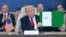 US President Donald Trump shows a signed document during a summit on Gaza in Sharm el-Sheikh on October 13, 2025.