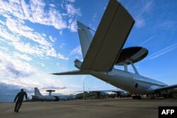 Член екіпажу перевіряє літак системи повітряного попередження та управління НАТО (AWACS), який бере участь у багатонаціональних навчаннях Air Defender 23 під керівництвом Німеччини на військовій базі Гайленкірхен, Німеччина, 20 червня 2023 року