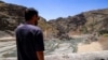 A man views the low water inlet upstream of the Amir Kabir Dam on the Karaj River in Iran's northern Alborz mountains in June.