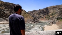 A man views the low water inlet upstream of the Amir Kabir Dam on the Karaj River in Iran's northern Alborz mountains in June.