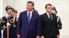 Chinese leader Xi Jinping stands next to French President Emmanuel Macron during a welcome ceremony in Beijing on December 4.