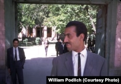 "The Higher Teachers College was a two-year institution for training college-level teachers, located at Seh Aqrab Road and Pul-e Surkh Road, on the west side of Kabul, near Kart-e Sei," recalls Peg Podlich. In this photograph, a Mr. Bahir (left), who was William Podlich's counterpart at the college, and an Afghan teacher pose outside the school.