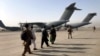 People line up to board a military aircraft as they are evacuated from Kabul. (file photo)