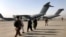 People line up to board a military aircraft as they are evacuated from Kabul. (file photo)