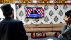 Afghan men watch a television broadcast of Donald Trump's victory speech at a restaurant in Kabul on November 6.