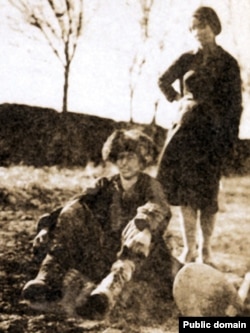 Знесилений від голоду казах і журналістка з Москви біля нього, яка, як зазначалося у підписі до фото, намагалася його врятувати. Казахстан, 1930 рік