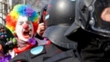 Germany--Frankfurt. An anti-capitalist protester dressed as a clown shouts behind policemen near the European Central Bank/ REUTERS/Michael Dalder 