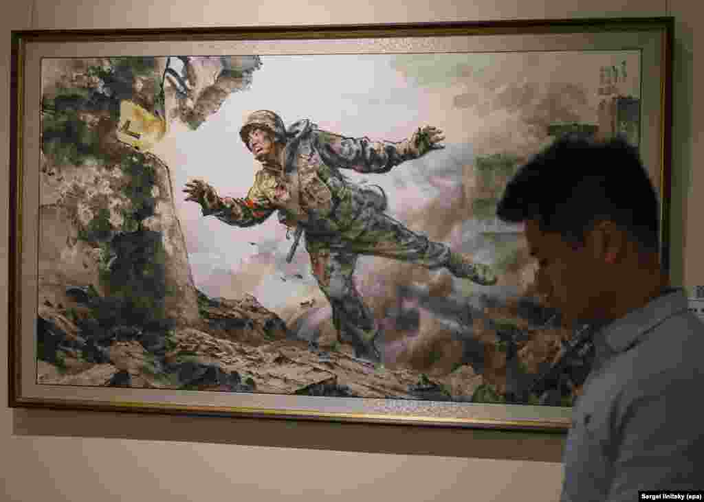 Один из экспонатов выставки - картина под названием "Отдавая мою бесценную жизнь". Как и другие выставленные в Москве картины, она изображает подвиги северокорейских солдат, отправленных воевать на стороне России против Украины. 