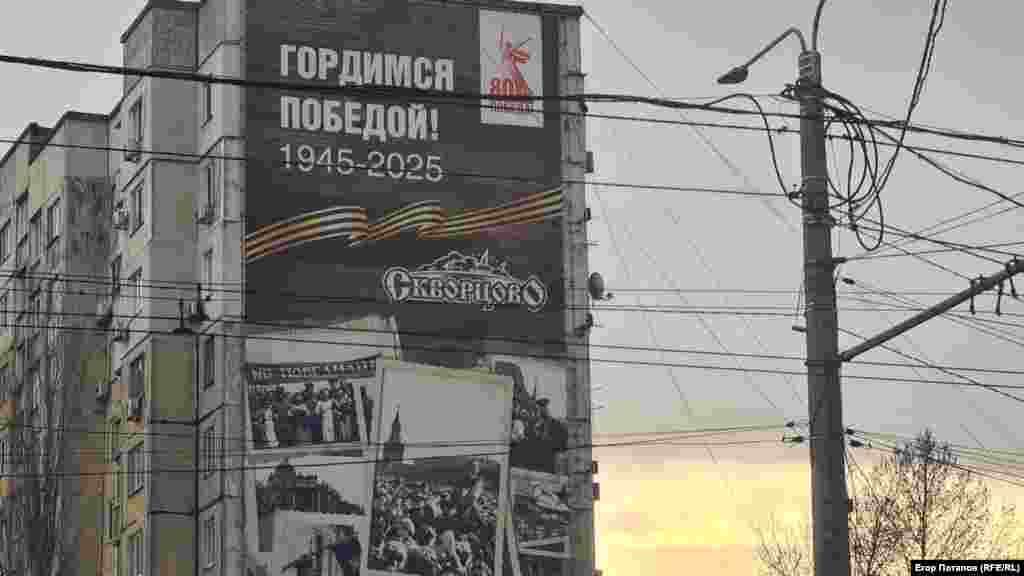 Мурал із написом «Гордимся победой 1945-1925» на стіні багатоповерхового будинку в Сімферополі
