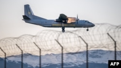 A Ukrainian military plane is seen landing at Geneva's airport on November 22 ahead of a meeting between Ukrainian and US officials.