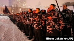 Members of the ultranationalist National Militia -- granted permission by the Central Election Commission to officially monitor Ukraine's presidential election on March 31 -- swear an oath of allegiance in central Kyiv in January 2018.