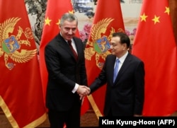 Milo Djukanovic (left), then Montenegro's prime minister, shakes hands with Chinese Premier Li Keqiang during their meeting at the Great Hall of the People in Beijing in November 2015.