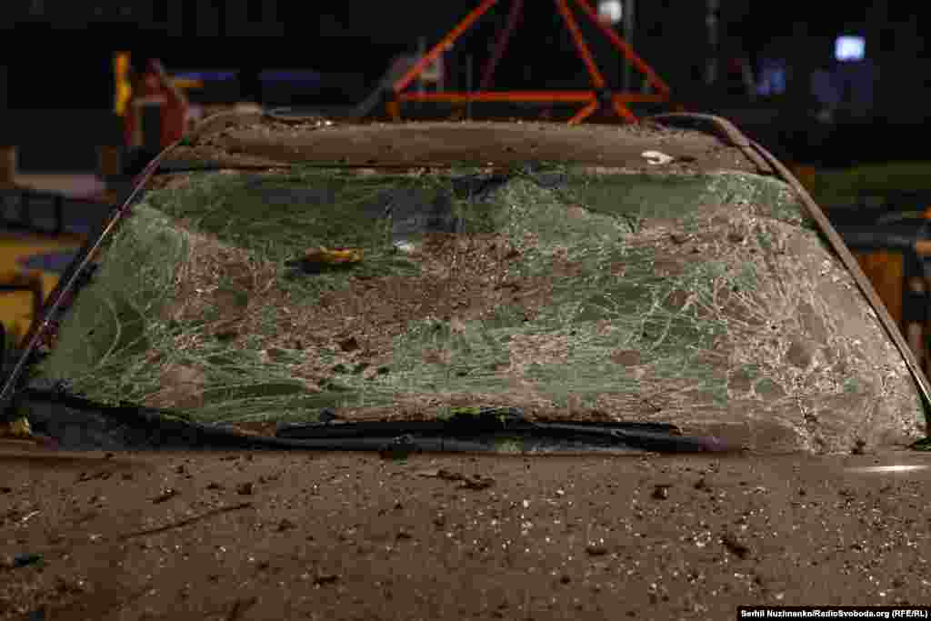 У результаті ударів армії РФ по Києву пошкоджені багатоповерхові й приватні будинки, автівки. На фото: позаду пошкодженої машини – дитячий майданчик. Київ, Солом'янський район, 29 листопада 2025 року