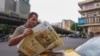 An Iranian man reads a newspaper on a Tehran street on April 12, 2025, with the front page featuring the Iran-US talks on the Iranian nuclear programme set to begin in Oman on the same day.