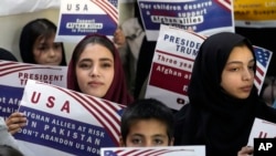 Afghan refugees rally in Islamabad after Washington suspended the U.S. Refugee Admission Program, on January 24.
