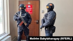 Сотрудники полицейского спецназа у двери редакции Orda.kz в Алматы. 1 декабря 2025 года