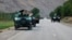 Afghan soldiers pause on a road at the front line of fighting between Taliban militants and Afghan security forces in the province of Badakhshan in northern Afghanistan on July 4.