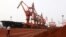 Soil containing various rare-earth elements waits to be loaded on to a ship at a port in Lianyungang, China. (File photo)