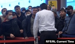 Central Asian migrants wait at a Moscow airport.
