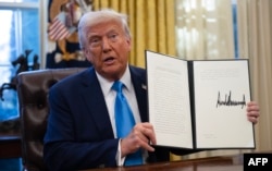 АҚШ президенті Дональд Трамп өз елі БҰҰ-ның бірқатар ұйымынан шығатыны жайлы жарлыққа қол қойғанын көрсетіп отыр. Вашингтон, 4 ақпан, 2025 жыл.