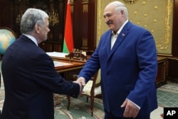 ალიაქსანდრ ლუკაშენკა (მარჯვნივ) და აშშ-ის პრეზიდენტის წარმომადგენელი ჯონ კოული ხელს ართმევენ ერთმანეთს მინსკში. 2025 წლის 11 სექტემბერი