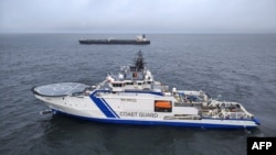 Корабель фінської прикордонної служби Turva (попереду) і нафтовий танкер Eagle S у морі біля Порккаланніемі