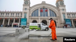 Дезинфекция багажа перед одним из железнодорожных вокзалов в Китае.