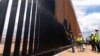 US says entire southern border wall with Mexico to be painted black to deter migrants