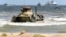 A Russian BTR-82A armored personnel carrier drives onto the shore during military exercises on the Caspian Sea coast in Daghestan in September 2019.