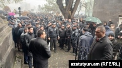 Armenia - Police and other security personnel guard the entrance to the Holy Mother of God Cathedral, Gyumri, December 7, 2025.