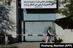 A man walks past an entrance gate with a sign of the Ministry for the Promotion of Virtue and Prevention of Vice, which replaced the ministry of women's affairs, in Kabul. September 17, 2021